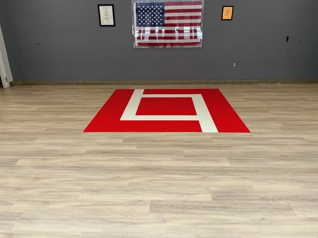 Wood-look LVP flooring with a custom logo inlay in a Connecticut commercial space