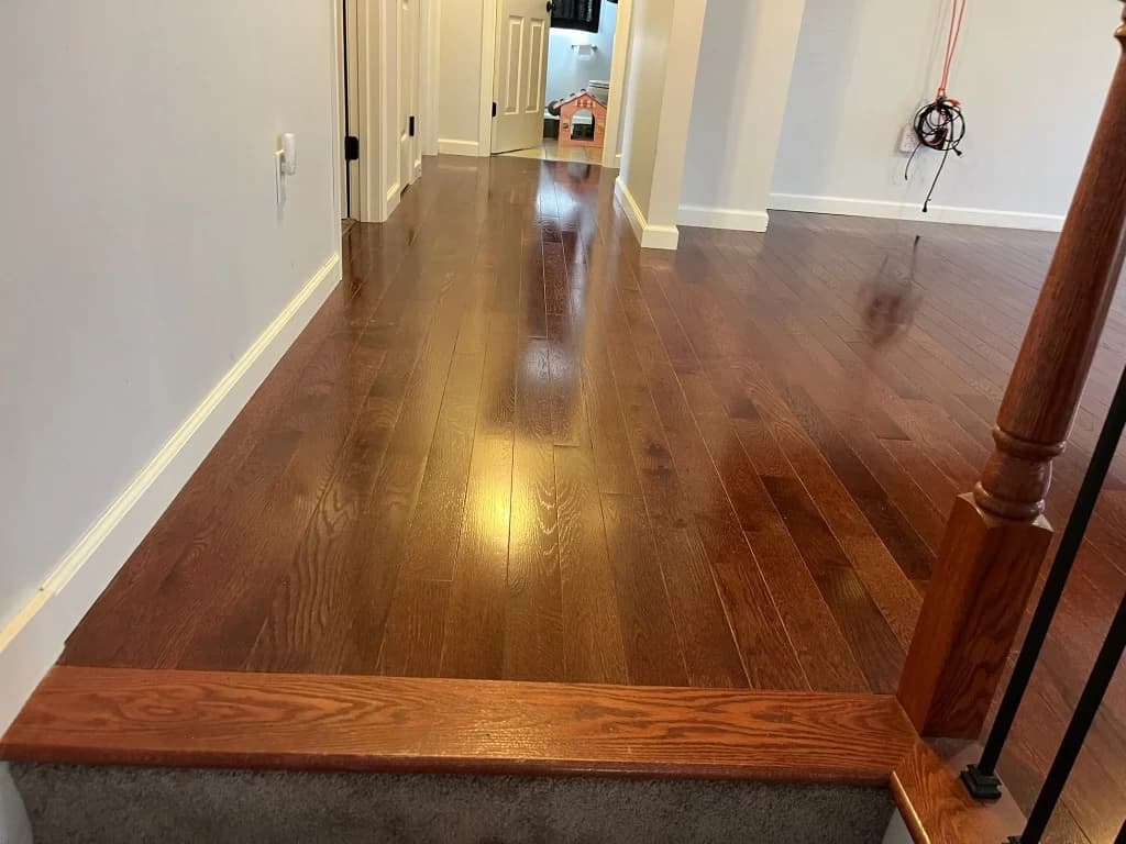 Glossy hardwood hallway flooring installed in a Connecticut home