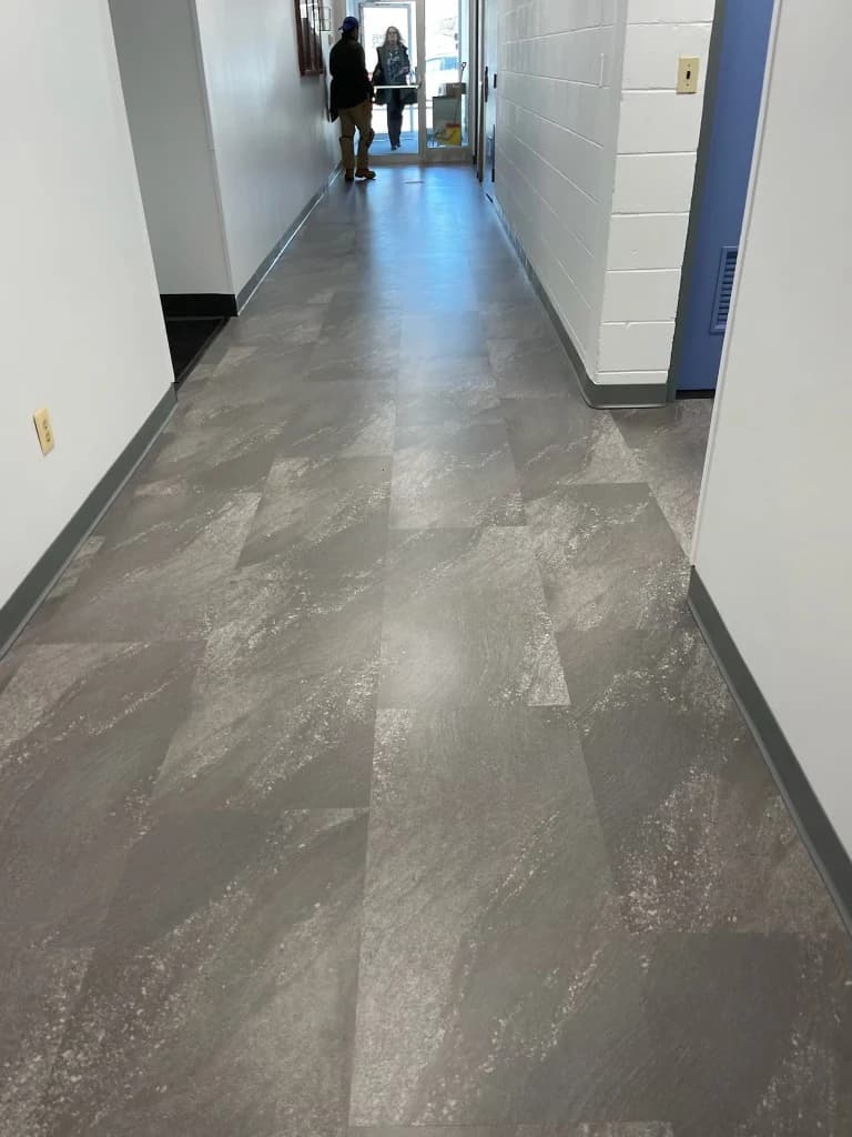 Gray stone-look tile flooring installed in a Connecticut commercial hallway