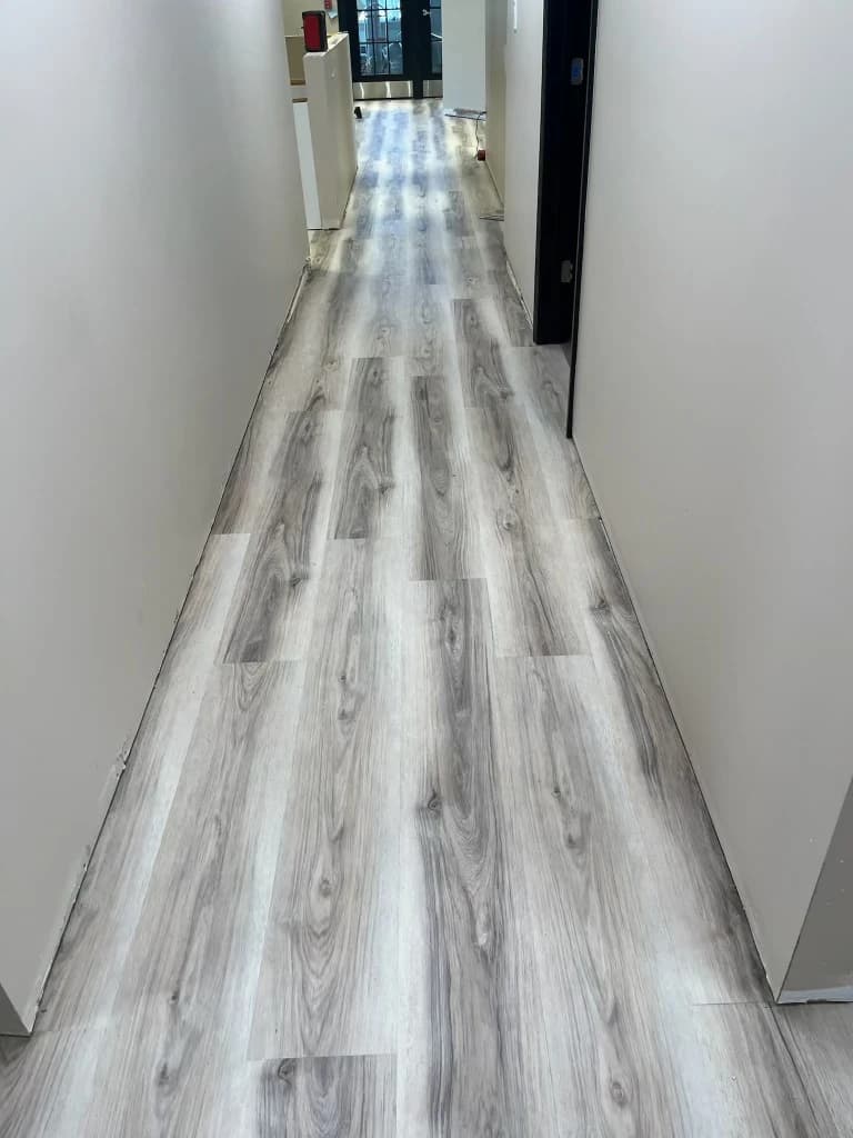 Gray wood-look flooring installed in a Connecticut commercial hallway