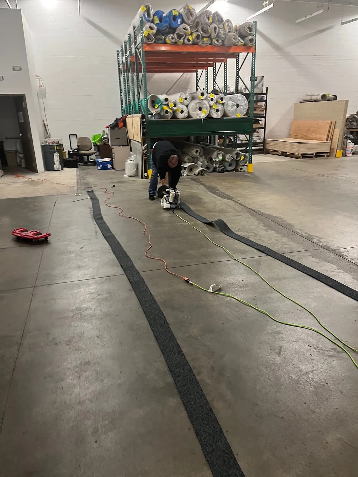 Carpet binding and seam work in progress at a Connecticut warehouse